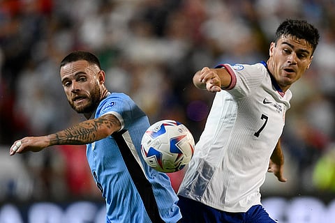 Nahitan Nandez and Gio Reyna battle for the ball